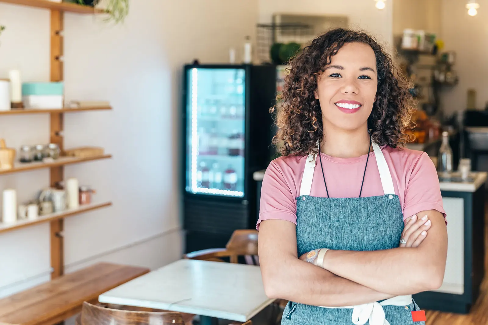 A business owner smiling in her own café