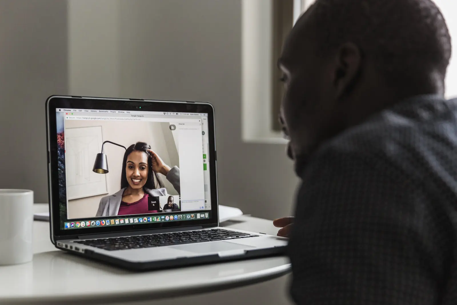 Two people on a video call from a laptop